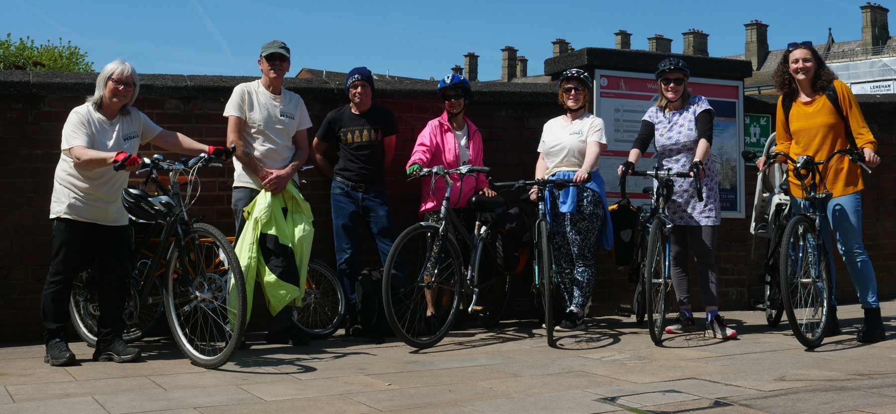 Group of Preston Pedals cyclists with their bikes at a station
